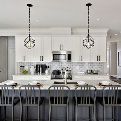 Neutral coloured kitchen with a dark grey island and white cabinets